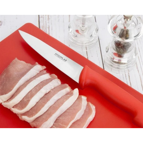 Raw meat on a red chopping board with red knife