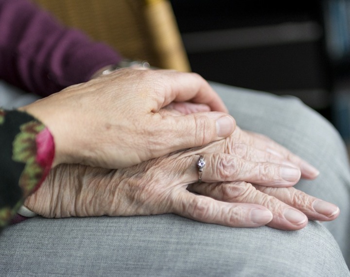 Senior woman with hands on lap
