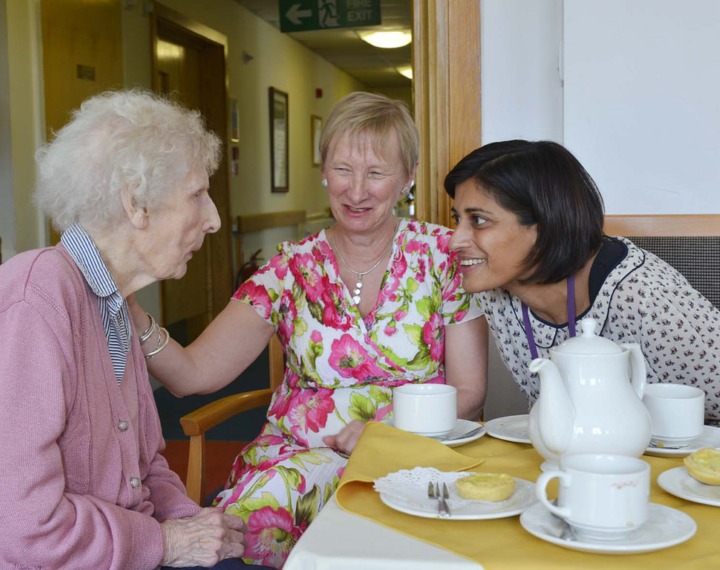 Happy staff conversing with resident