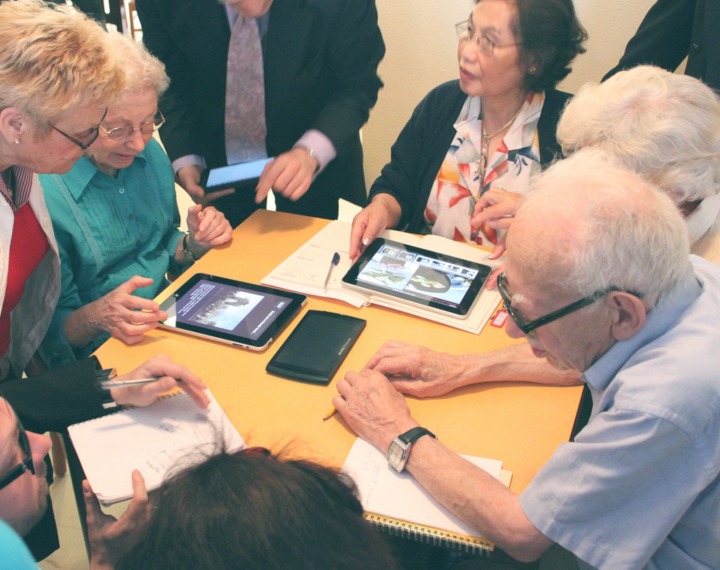 Seniors using technology in group