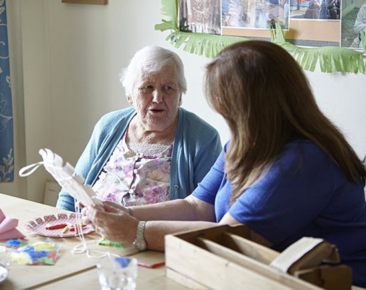 Volunteer doing crafts in care home