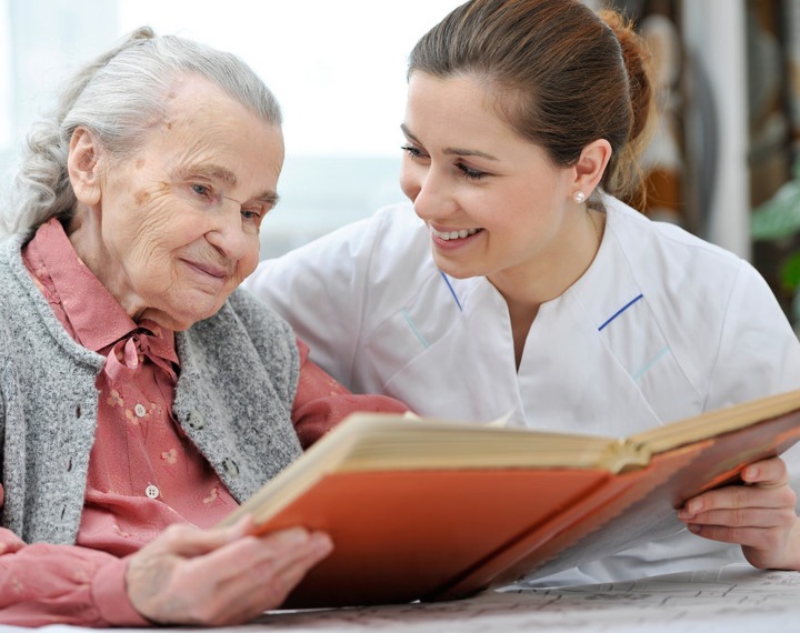 Carer reading with resident