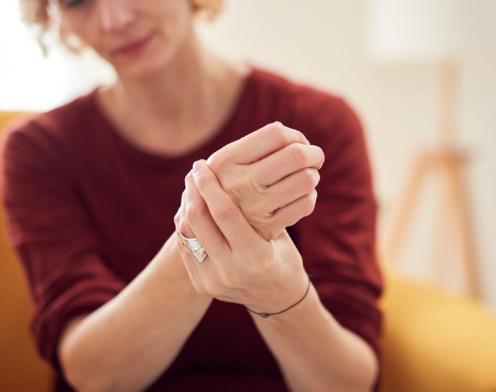 Young woman with rheumatoid arthritis in hand