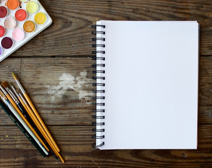 Activity table with paints, paint brushes and pad