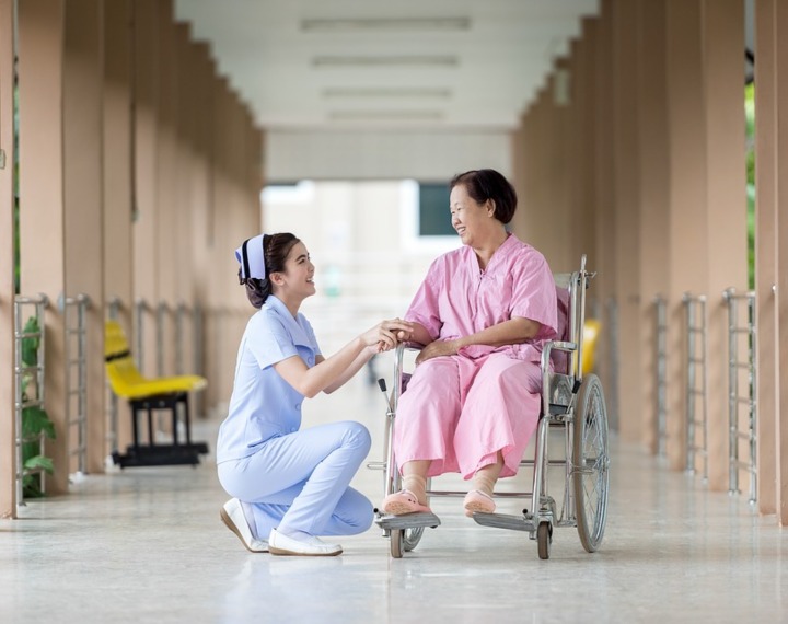 Patient in wheelchair with carer